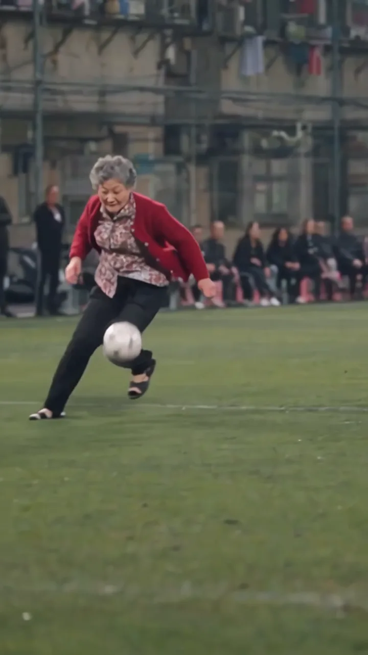 Frame from the generated Ozil Goal AI example showing the grandmother with a football